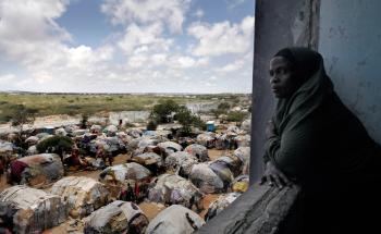 A woman looking outside an internally displaced people camp