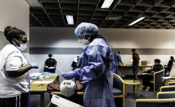 A picture of Bhelekazi Mdlalose and another MSF staff member doing COVID-19 health promotion in Johannesburg, South Africa.