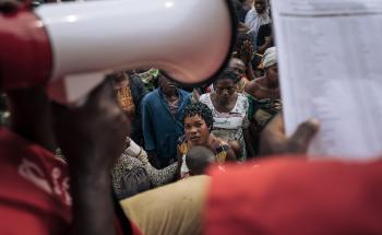 Hundreds of conflict-displaced people wait for a distribution of household kits (pots, blankets, soap, etc.) at the informal IDP site of Rugabo Stadium in Rutshuru Center on July 18, 2022, in North Kivu province, eastern Democratic Republic of Congo.