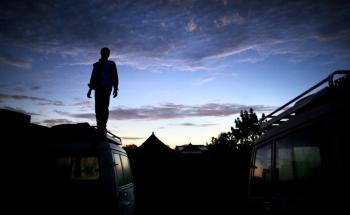 MSF staff member standing on an MSF vehicle while on a mission to reach people with sleeping sickness.
