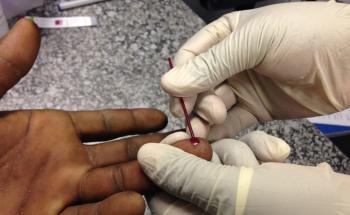 MSF staff member taking out blood for an HIV test