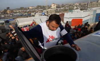 MSF water and sanitation agent, inspects the water truck during a distribution in the Tal Al-Sultan area of the southern Gaza town of Rafah.
