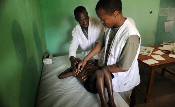 MSF staff examining a young boy