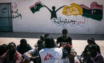 A woman with burns detained in Sorman at female-only detention centre around 60km west of Tripoli, Libya. She is assisted by another detainee.