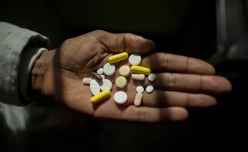 Simphiwe holds his medication, he takes up to 26 pills a day to treat XDR-TB. Here he holds his morning selection, which includes delamanid, one of the newest DR-TB drugs, which Simphiwe is taking for the first time today.