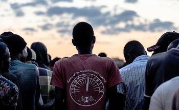 Men stand in line to receive blankets which were being distributed by a local group to men staying at a men's shelter for refugees in Musina, South Africa.