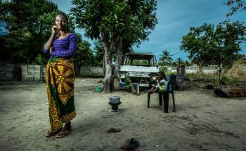 Portrait of sex worker Aida at her home with one of her children