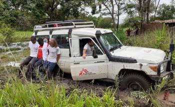 MSF logistics team crossing the river after the bridge was washed away