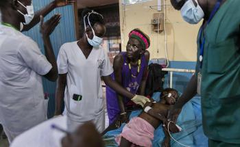 Atong Dut Deng, 8 years old, infected with celebral malaria. She is being attended to by MSF medical staff in the ICU at MSF supported Aweil State Hospital.