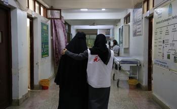 MSF midwife supervisor, Taqwa Abdulghani, Hassan assisting a mother Aiesha* to walk after she went through caesarean section for birth of her daughter at Al-Jamhouri hospital in Taiz City, Yemen.