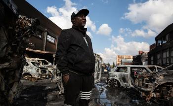 15 July 2021. A business owner surveys the damage to his panelbeating workshop in Malvern, Johannesburg. Picture: James Oatway.