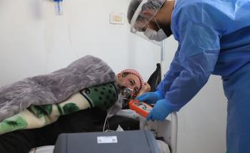 Nurse checking a patient’s oxygen level inside the ward for patients with suspected COVID-19.