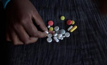 A patient taking her medication against TB