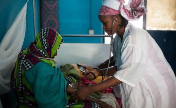 MSF staff member taking blood pressure of a patient in Timbuktu, Mali.