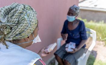Patient (Phenduka Mtshali) infected Drug Resistant Tuberculosis (DR-TB), at her home in Mbongolwane, South Africa speaking with our MSF fieldworker, Jabulile.