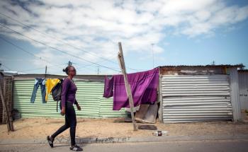 XDR-TB patient walks home from her local clinic. Khayelitsha, Western Cape, South Africa.