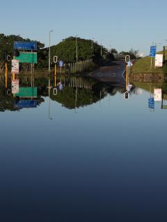 Traffic lights poke out of the water covering a flooded intersection in eThekwini in South Africa. The flood was a climate emergency.