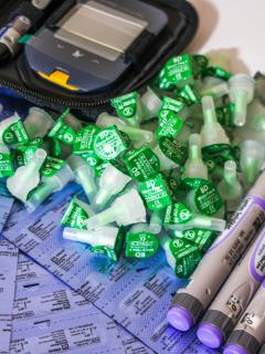 A collection of insulin pens and needle caps beside a glucometer used to treat diabetes at the MSF clinic in Arsal, north Lebanon