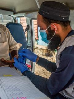 an MSF nurse collects a blood sample from a patient suspected of having Hepatitis C