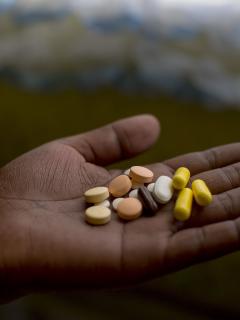 Patient Nanyanyiso Baloi holds her treatment regimen for pre-XDR-TB, which includes delamanid and bedaquiline. Khayelitsha, Western Cape.