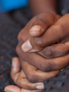 A women sits with her hands clasped in her lap. MSF, Doctors Without Borders, Safe Abortion care 