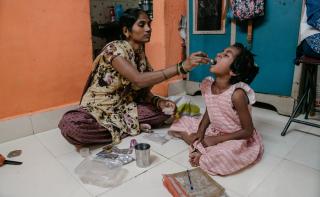 Vaishnavi, a 7-year-old DRTB (Drug Resistant​ Tuberculosis) patient being given her TB medication by her mother Vishakha.​
