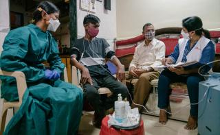 Prachi an MSF nurse talks to Ramesh Narsing​ Kharatmol father of Chetan Ramesh Kharatmol (23), a DRTB (Drug Resistant Tuberculosis) patient, as Ankita, another nurse looks on.​