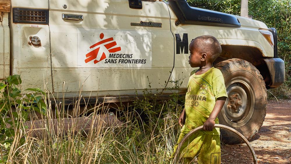 A child next to an MSF vehicle out of Kaboro malaria point in Kaboro, Ouham.