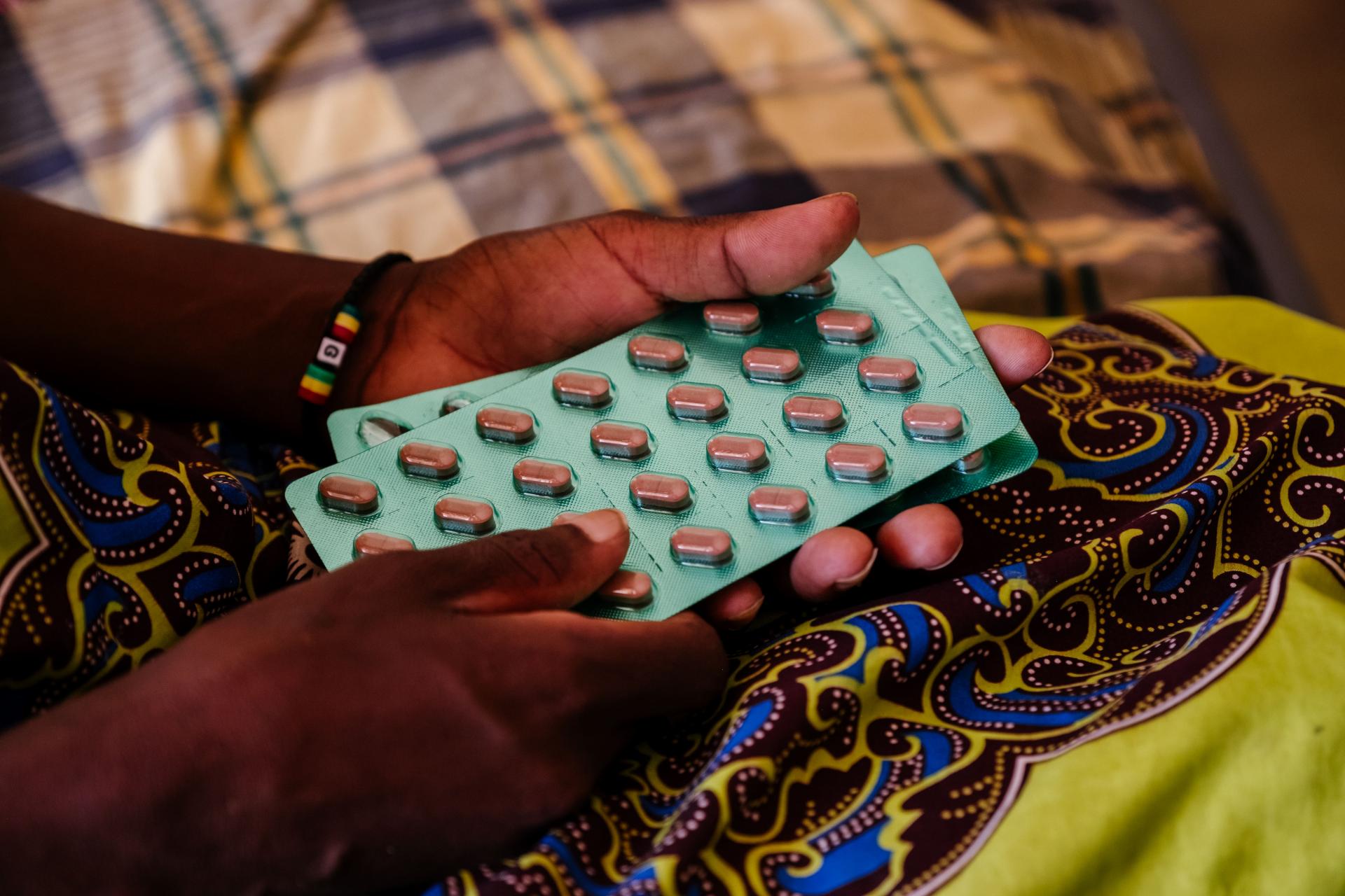Ether, an advanced HIV patient, with her medication in her hands, in a female ward at Nsanje District Hospital, Malawi. 