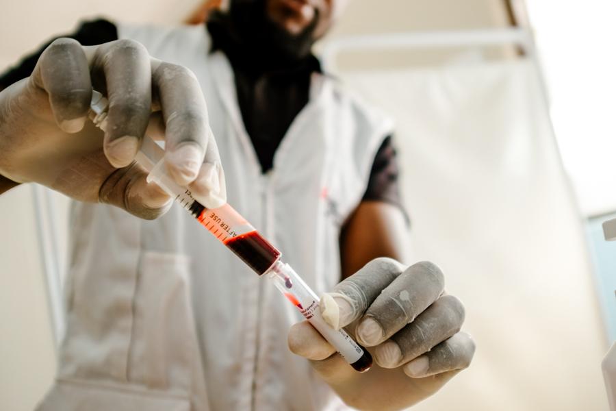 Nelson Chidanti, MSF Clinical Officer helping the nurse to collect blood sample in Rapid Assessment Unit (RAU) at Nsanje District Hospital.