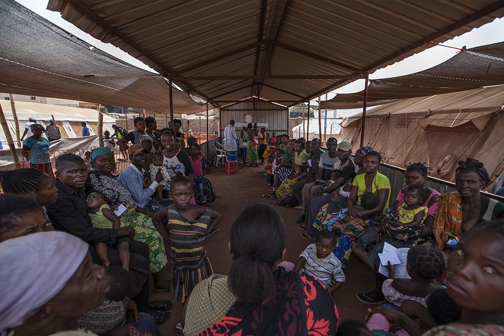 Refugees wait to be vaccinated at the MSF clinic in the Cacanda camp