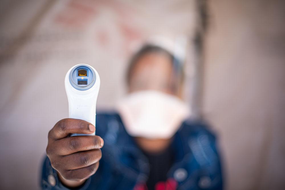 A picture of a healthworker holding a thermometer in Eshowe