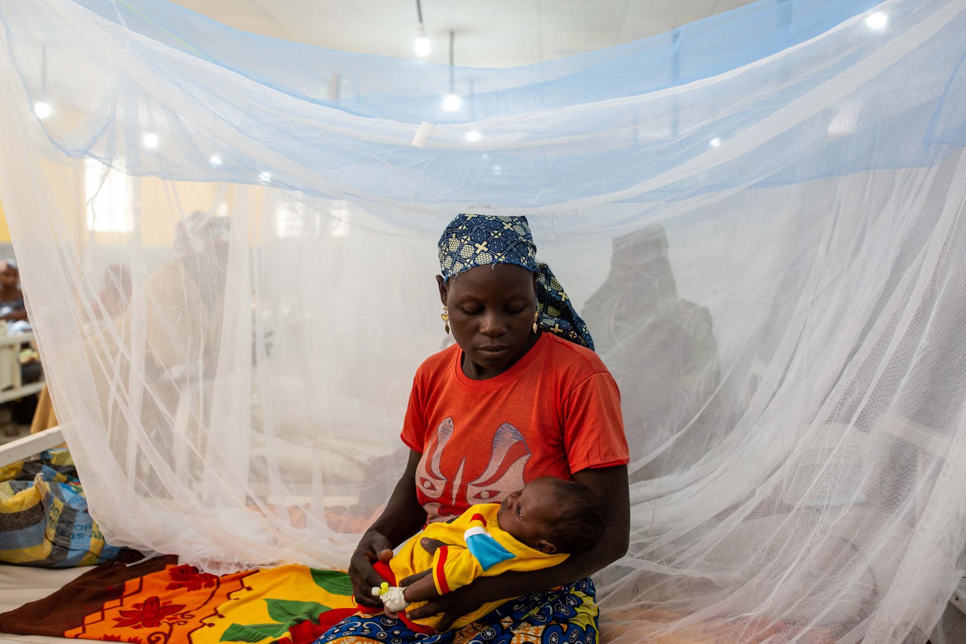 A mother cradles her sick baby in the children’s ward at Mora General hospital. Far-North, Cameroon, March 2020.
