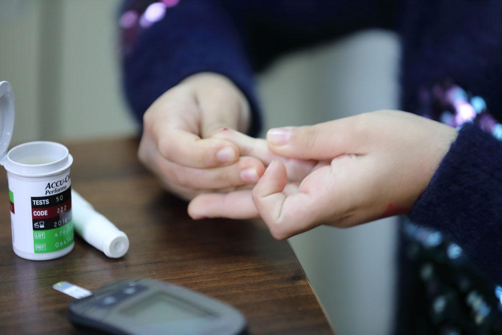 A picture of a patient taking a diabetes test