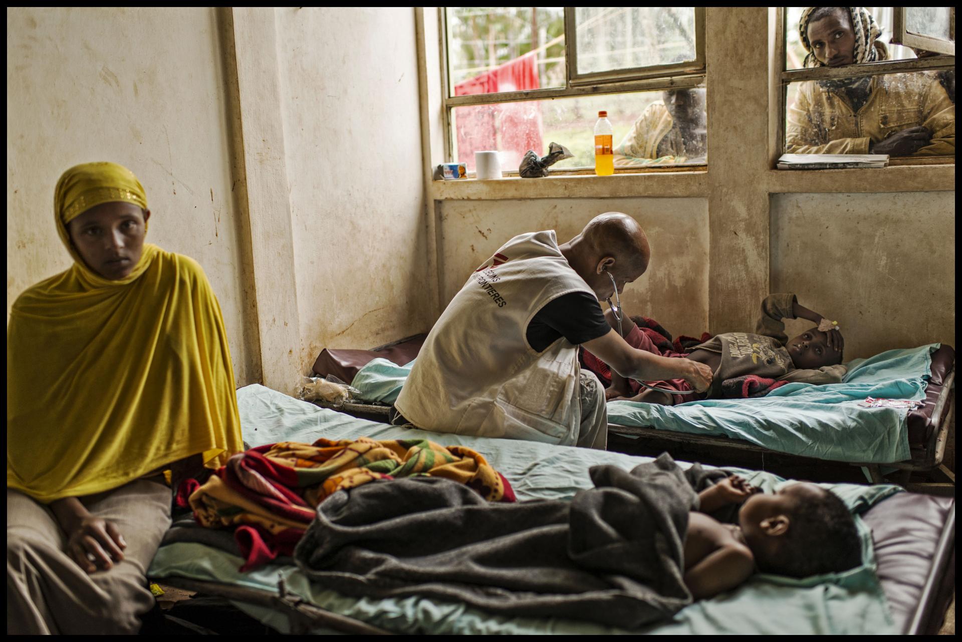 An MSF medical staff conducting a check up on a child in Sidama. Ethiopia, September 2014.