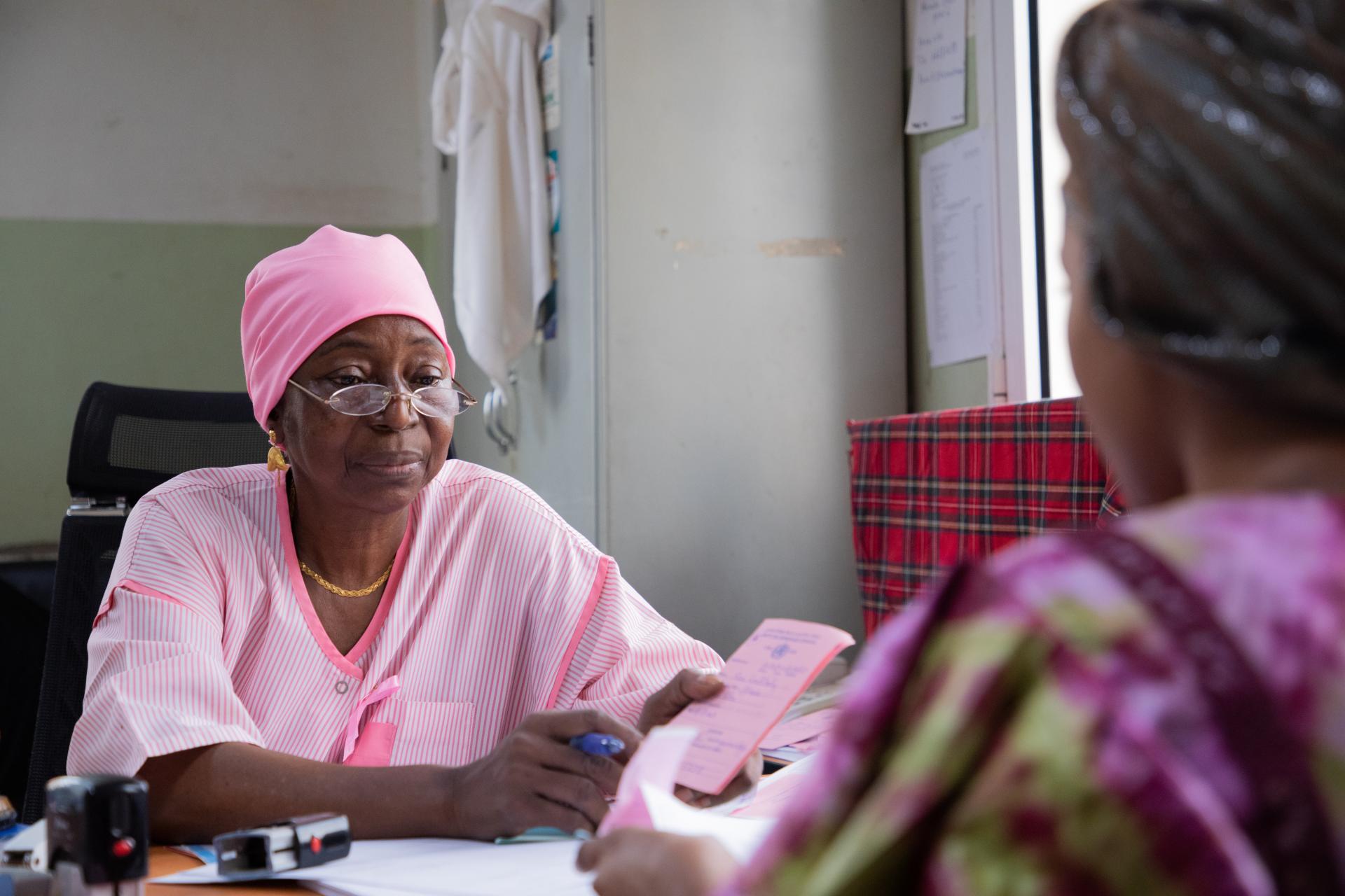 Nene Sow, MSF midwife, talks with her patient after screening her for breast and cervix cancer at Gabriel Toure hospital in Bamako, Mali 
