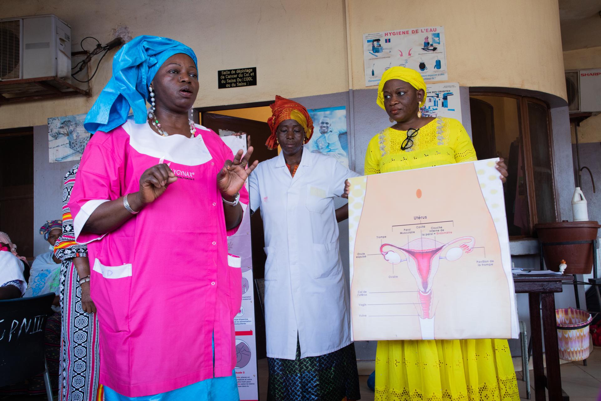 Dr Mama Sy Konaké (left) and colleagues promote breast and cervical cancer awareness at the Commune VI referral health centre, Bamako.