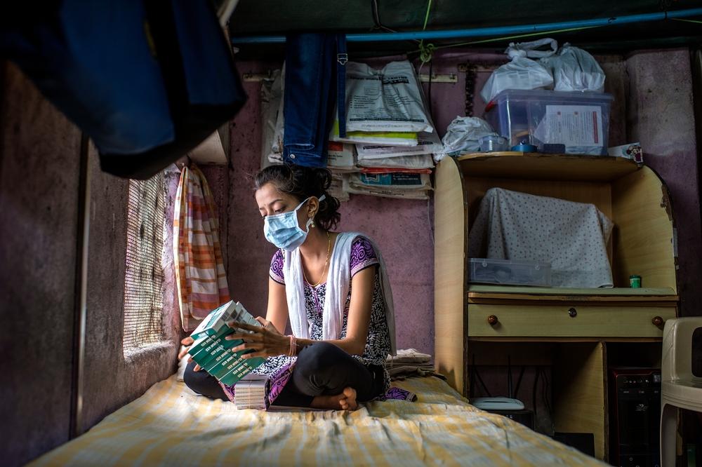 An XDR-TB patient looking at her boxes of TB medication in Mumbai, India