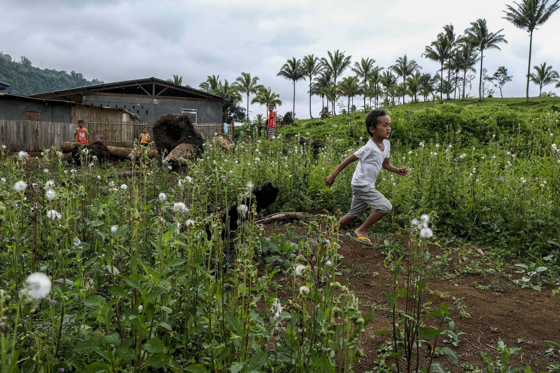  Displaced children playing in the open fields in Cambodia