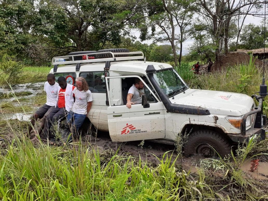 MSF logistics team crossing the river after the bridge was washed away