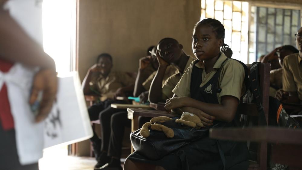 Health workers addressing school children about mental health in Liberia