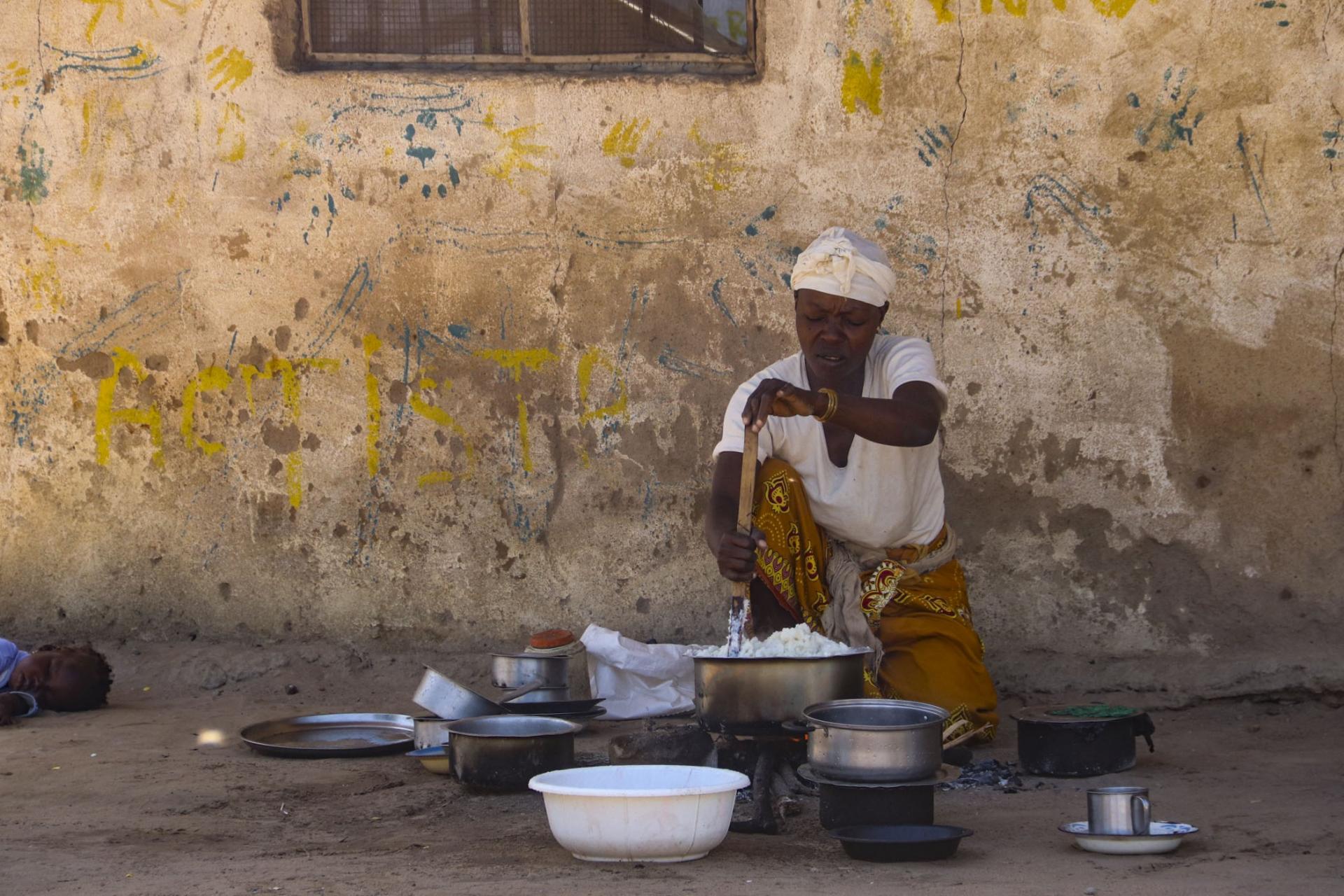 A woman cooking food at internally displaced people's camp. Mozambique, June 2020