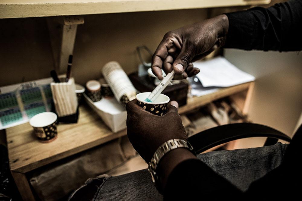 Detail of the methadone syrup and single-use cups with which beneficiaries of the heroin substitution programme take their dosage. The dosage is set by a doctor at the Alto-Mae health centre.