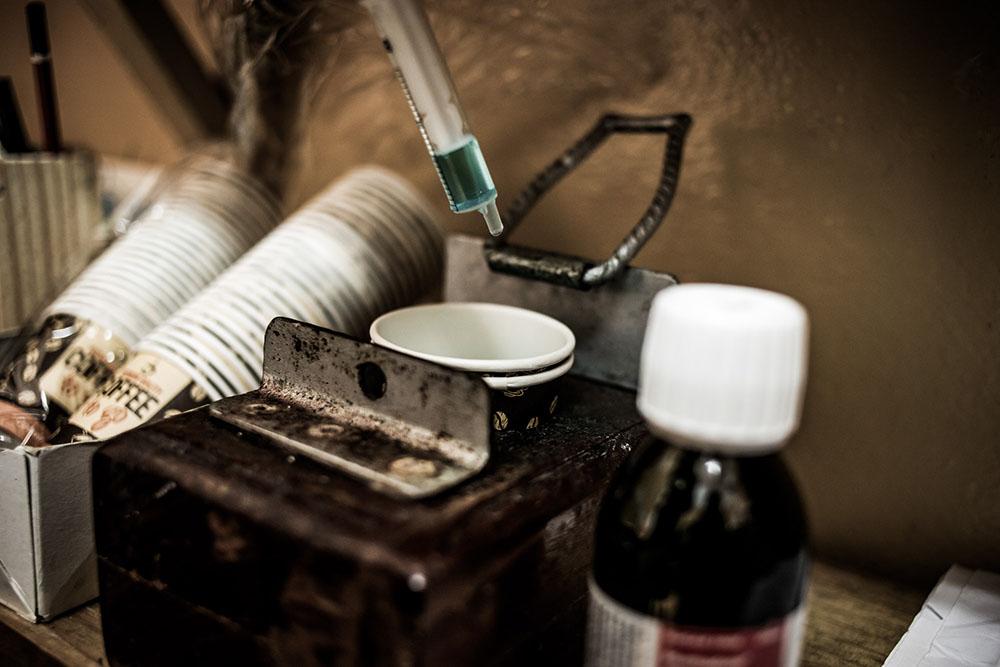 Detail of the methadone syrup and single-use cups with which beneficiaries of the heroin substitution programme take their dosage. The dosage is set by a doctor at the Alto-Mae health centre.