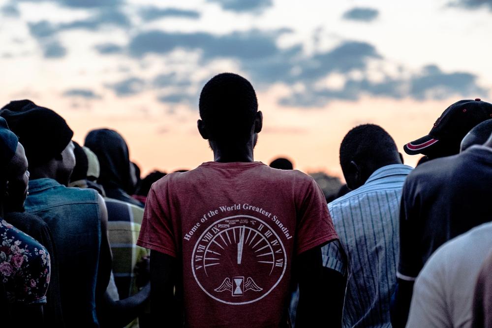 Men standing in line to receive blankets which were being distributed by a local group to men staying at a men's shelter for refugees in Musina, South Africa. 