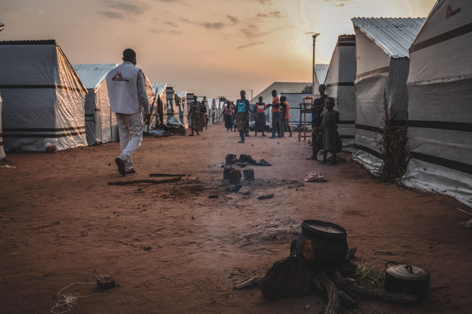 An MSF staff member walks through Mbawa internally displaced people's camp, where most of the displaced were uprooted by the so-called ‘farmer-herdsmen’ conflict. Benue state, Nigeria, June 2020.