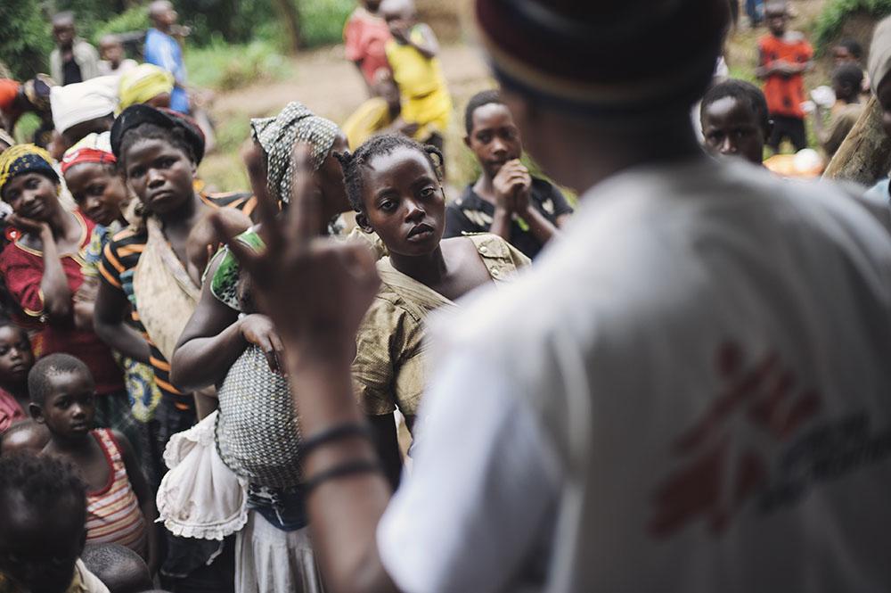 Mothers listen to Alpha Atafazali Bahunga telling them that they require three rounds of vaccination during a session in a church-cum-school in the village of Kalungu II in Masisi territory in the east of the Democratic Republic of the Congo on August 14, 2014.