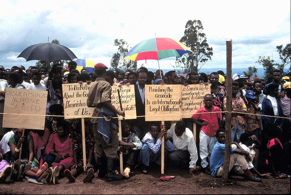 KIGALI, RWANDA, AFRICA, 30.04.95. Tutsi survivors of the genocide at the one year anniversary of the genocide. Beneath umbrellas. 