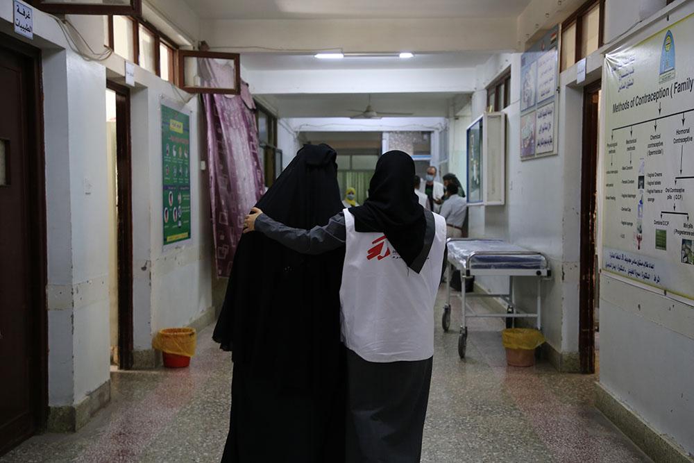 MSF midwife supervisor, Taqwa Abdulghani, Hassan assisting a mother Aiesha* to walk after she went through caesarean section for birth of her daughter at Al-Jamhouri hospital in Taiz City, Yemen.