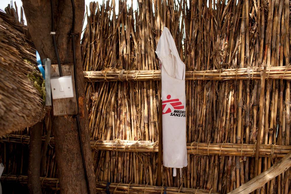 MSF vest hanging on a reed fence.